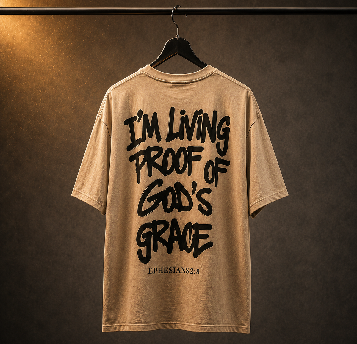 Beige t-shirt with black text on a hanger against a brown background