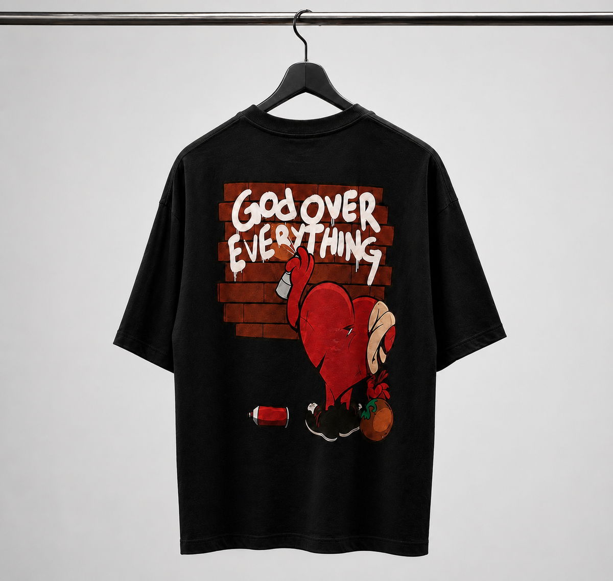 Black t-shirt with graphic design and text on a hanger against a gray background