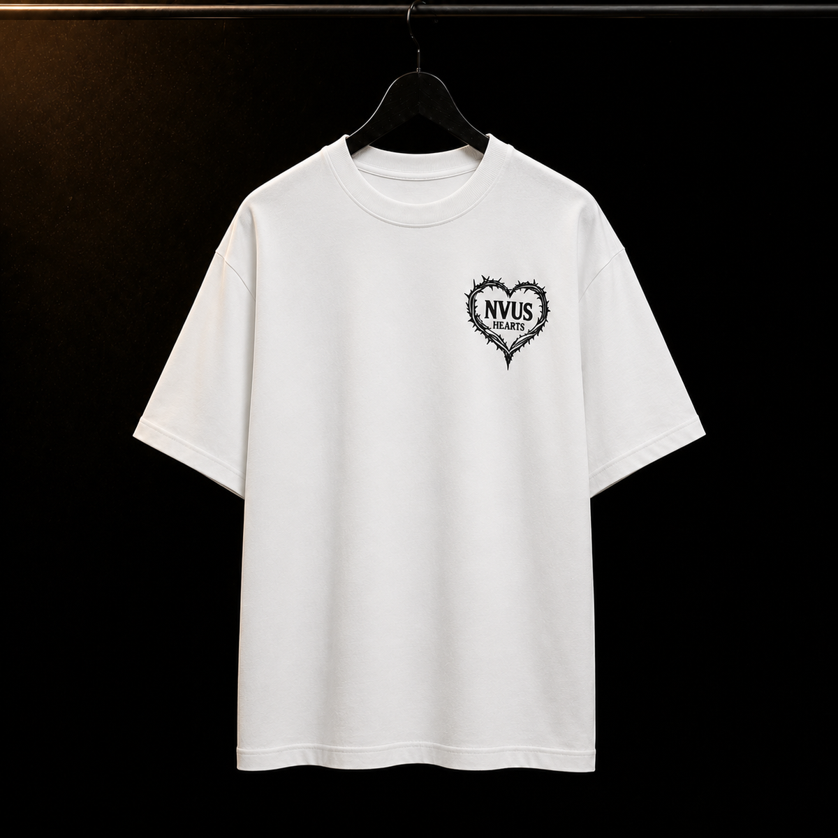 White t-shirt with black logo on a hanger against a black background